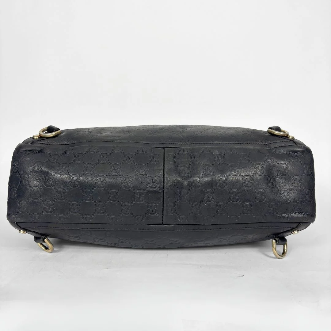 Black Gucci handbag on a white background