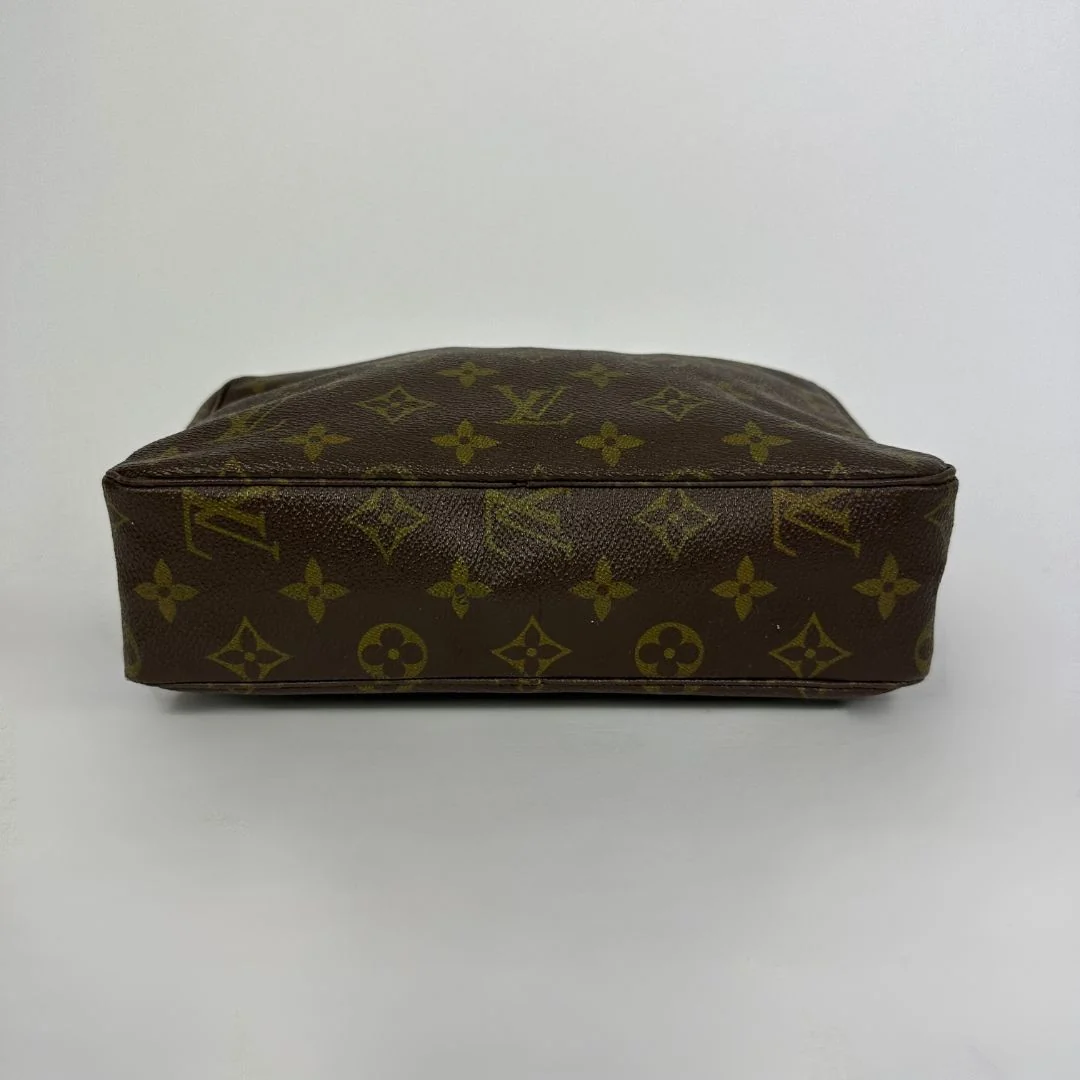 Louis Vuitton toiletry bag in front of white background