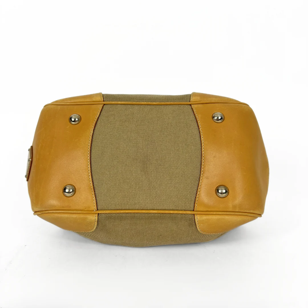 Brown leather and fabric handbag on a white background