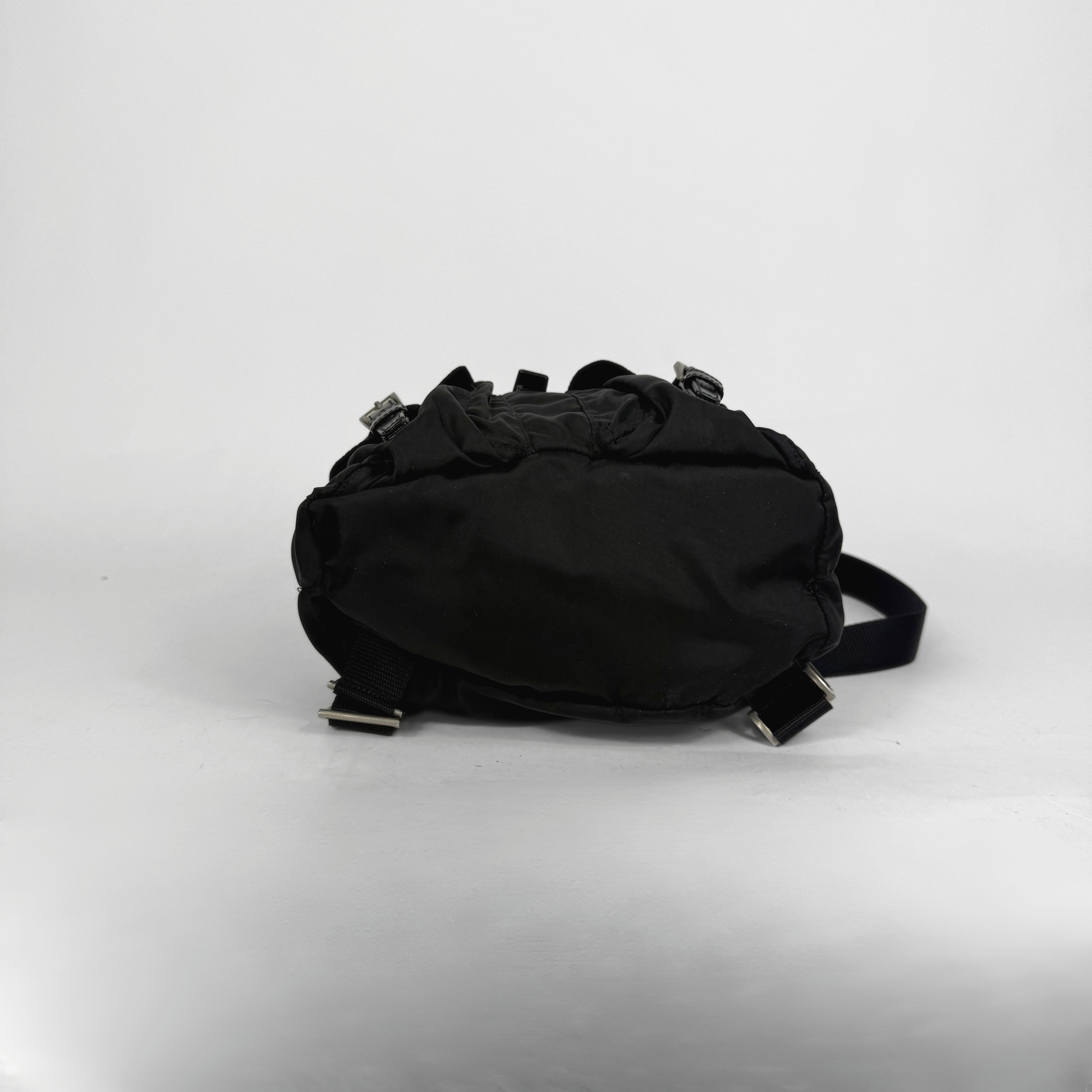 Black backpack on a light gray background