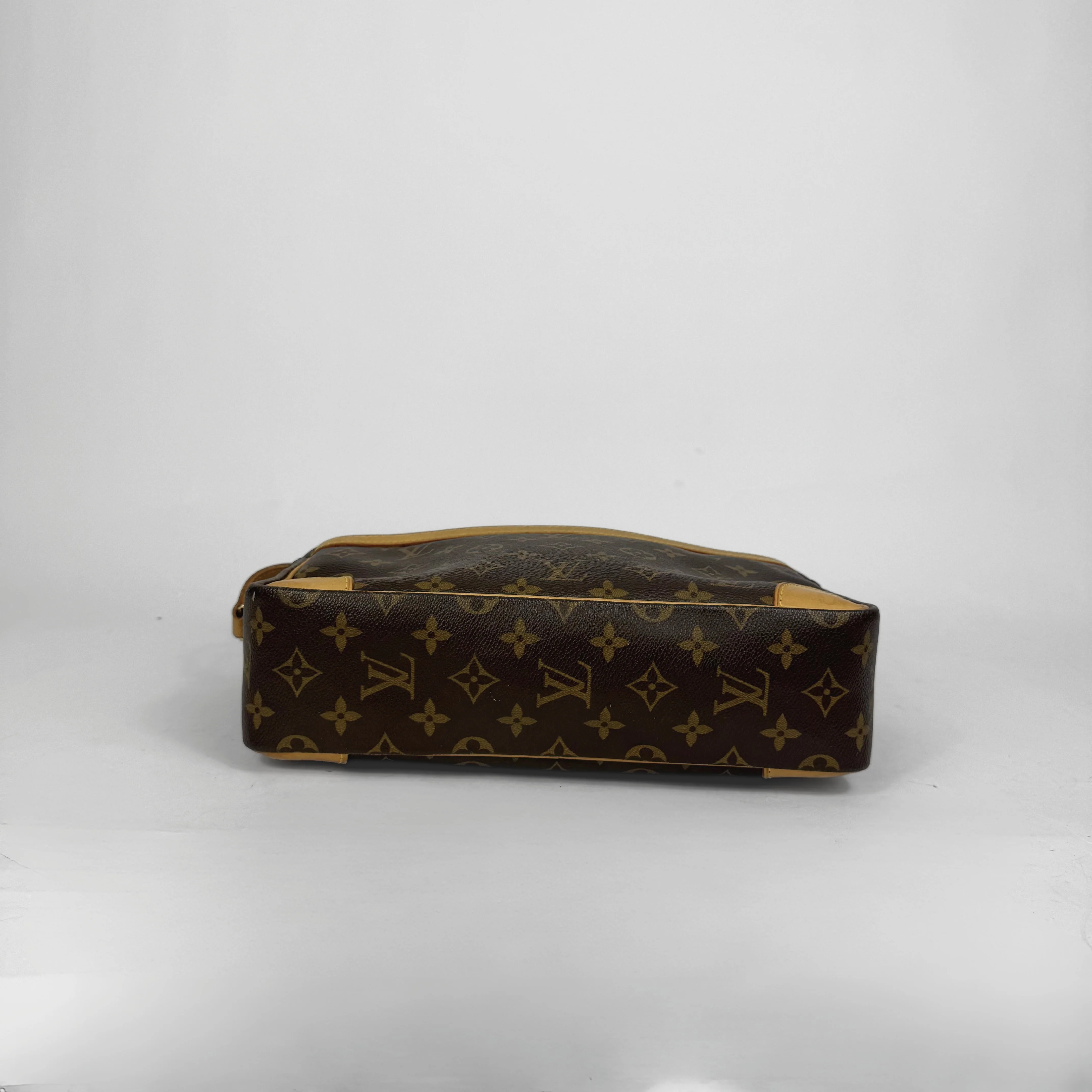 Designer handbag with monogram pattern on a white background