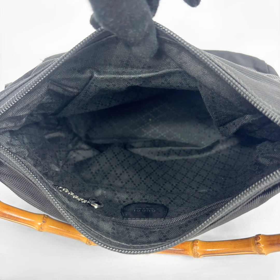 Black handbag with a bamboo handle on a white background