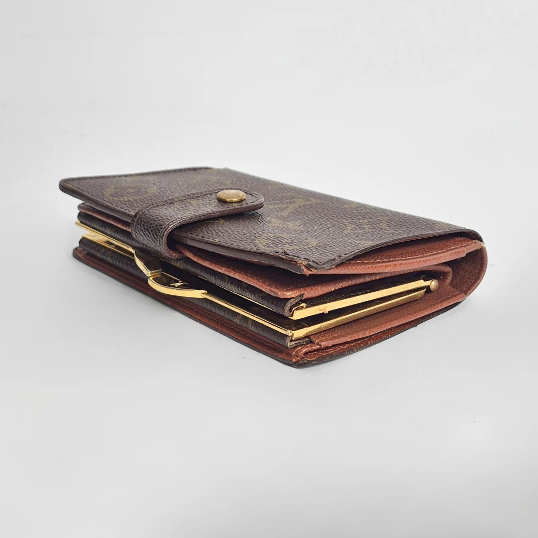 Brown leather wallet with gold accents on a light gray background