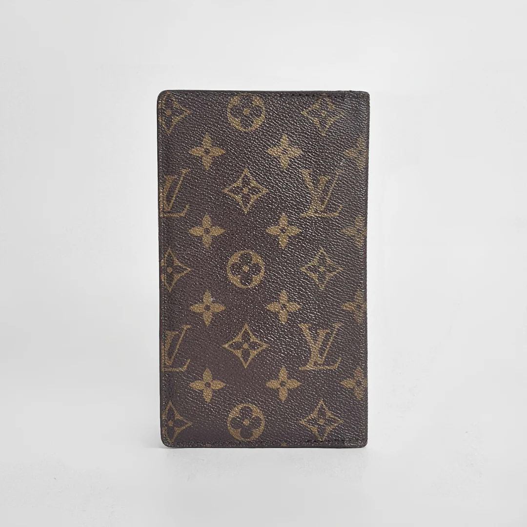 Louis Vuitton wallet with monogram pattern on a white background