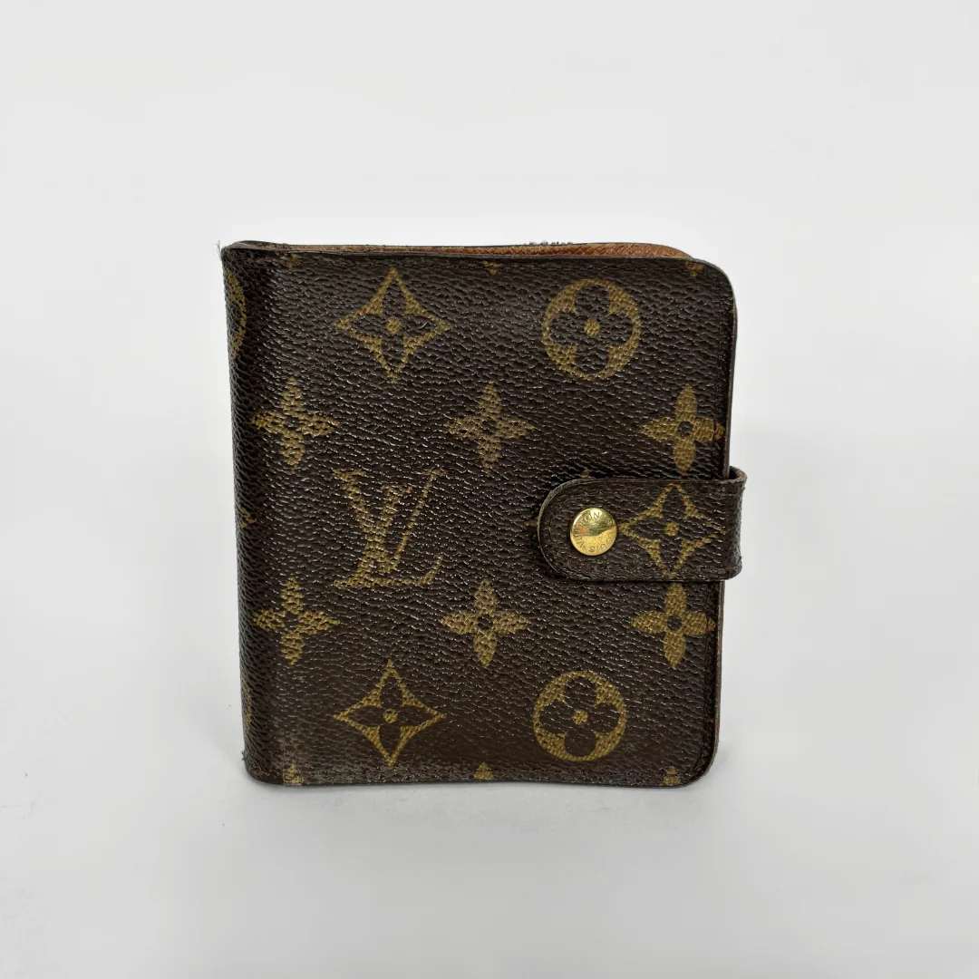 LV compact wallet in signature brown monogram canvas with a snap-button strap closure.