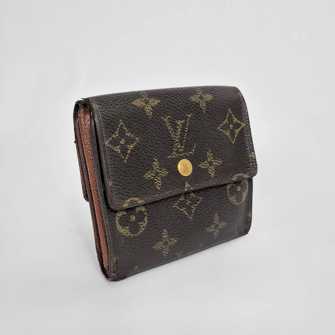 Louis Vuitton wallet with monogram pattern on a light gray background