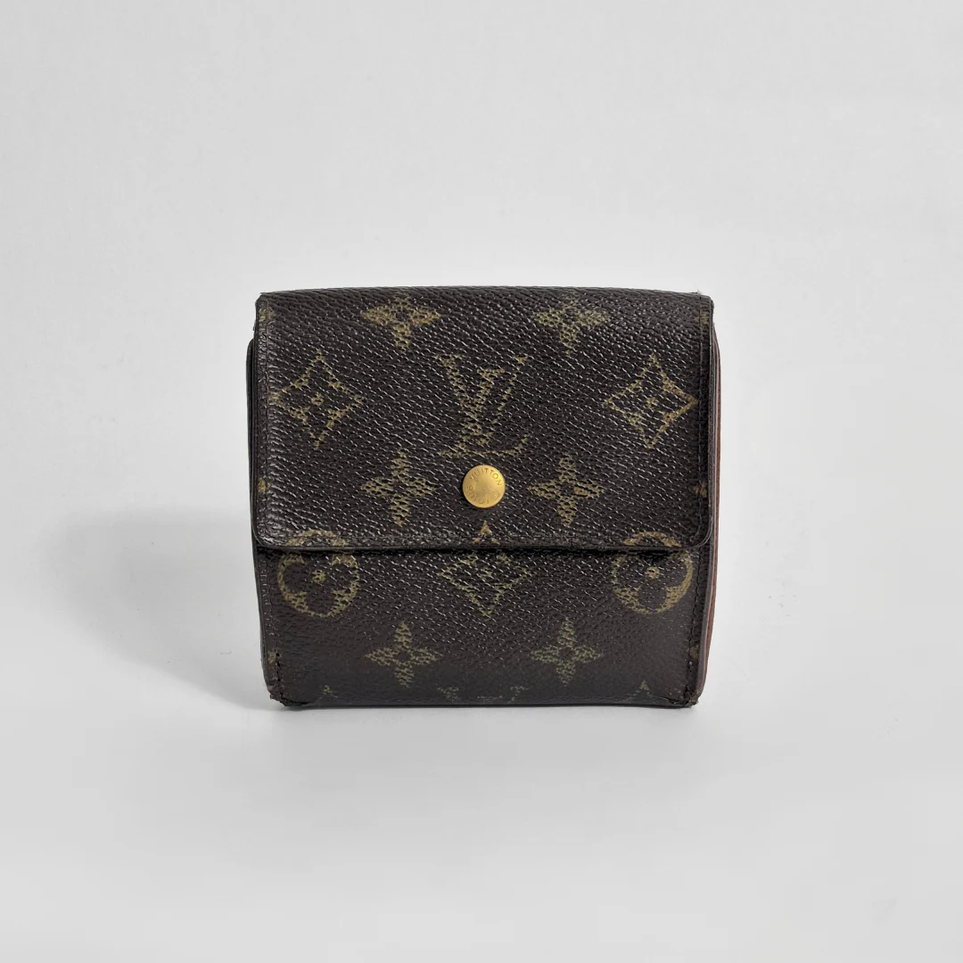 Louis Vuitton wallet with monogram pattern on a light gray background