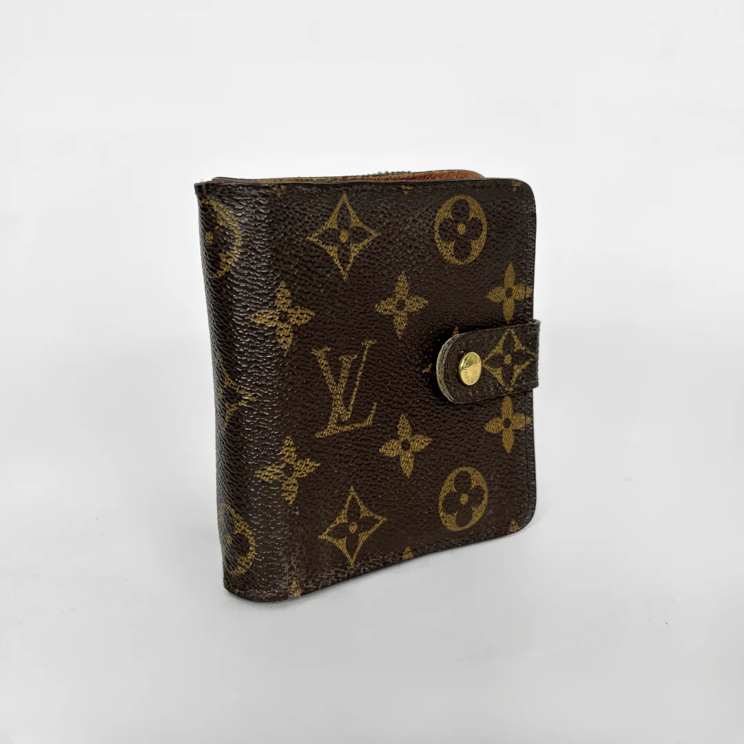 LV compact wallet in signature brown monogram canvas with a snap-button strap closure.