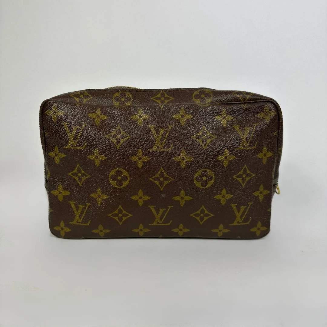 Louis Vuitton toiletry bag in front of white background