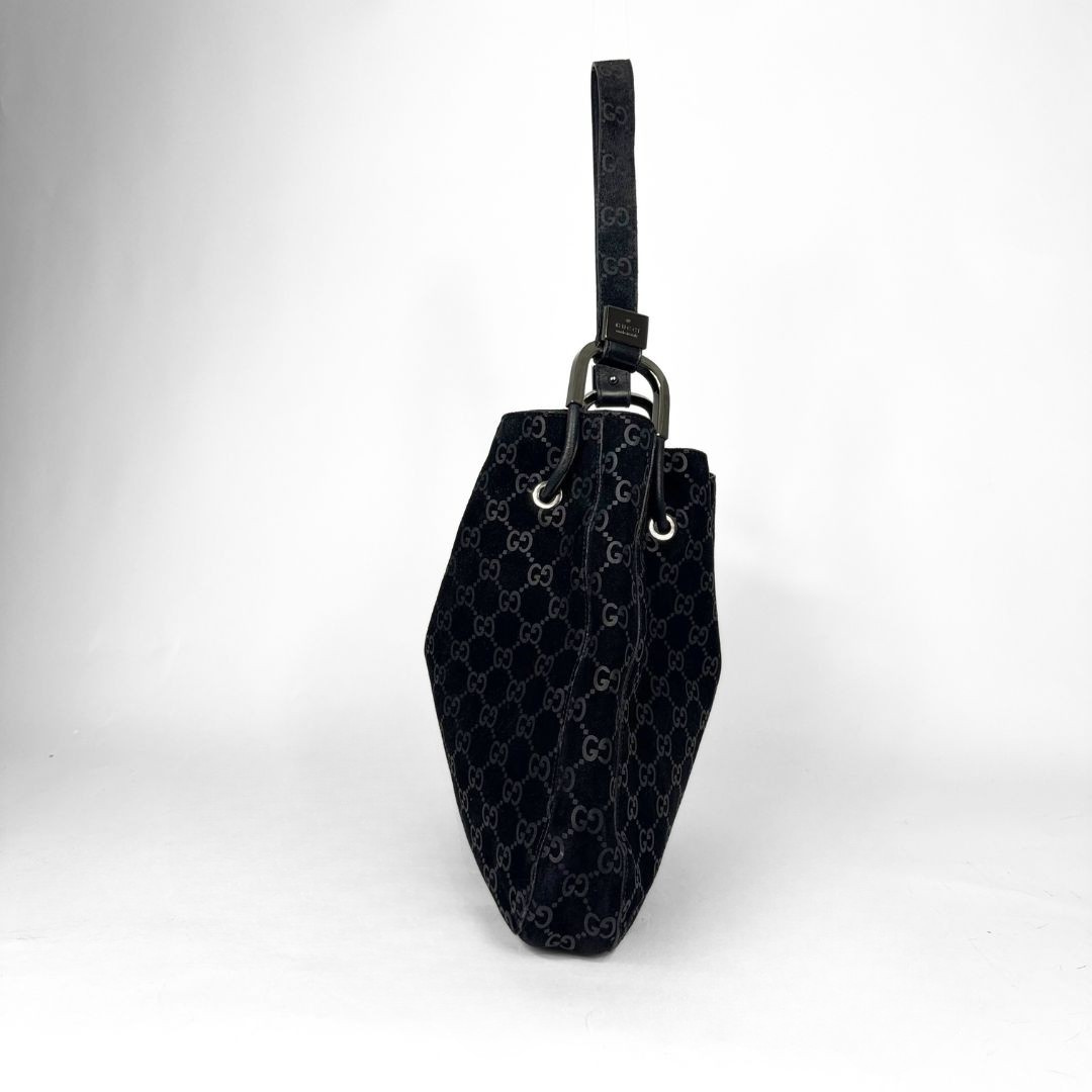 Gucci GG black suede shoulder bag on a white background
