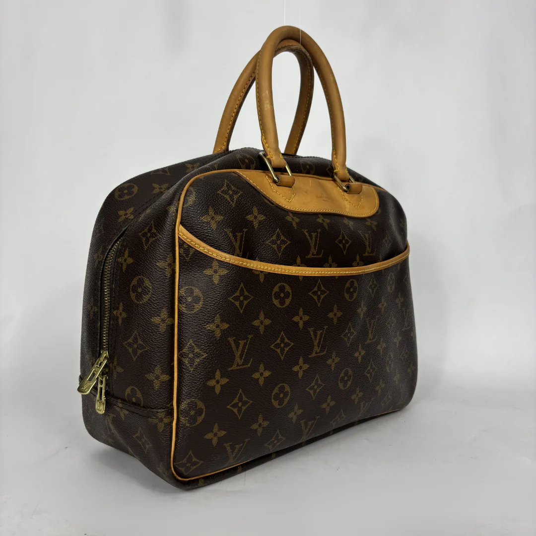 Designer handbag with monogram pattern on a white background