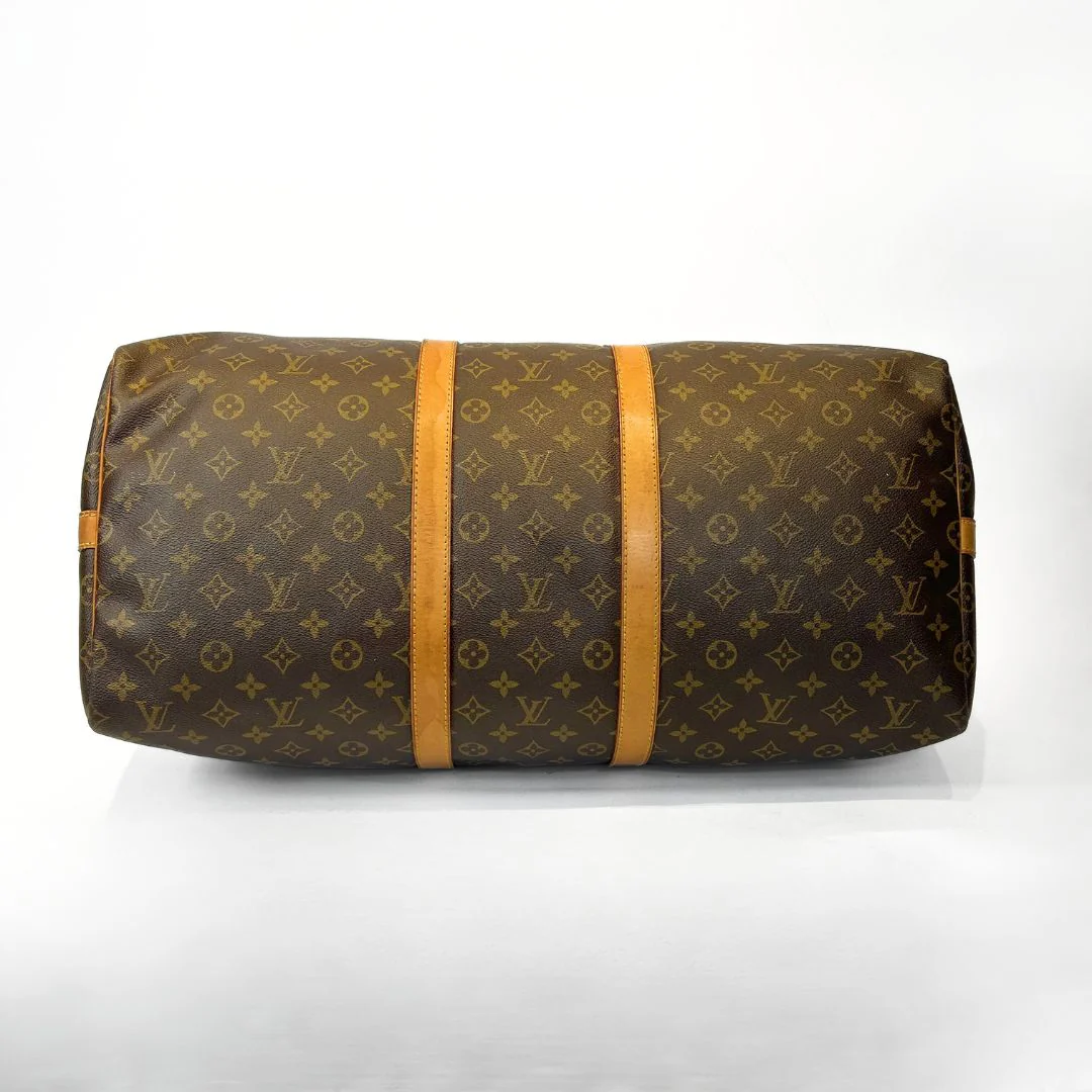 Louis Vuitton monogram duffel bag with orange straps on a white background
