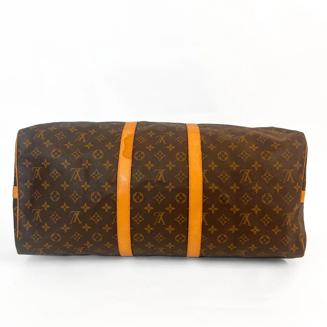 Brown travel bag with orange straps on a white background