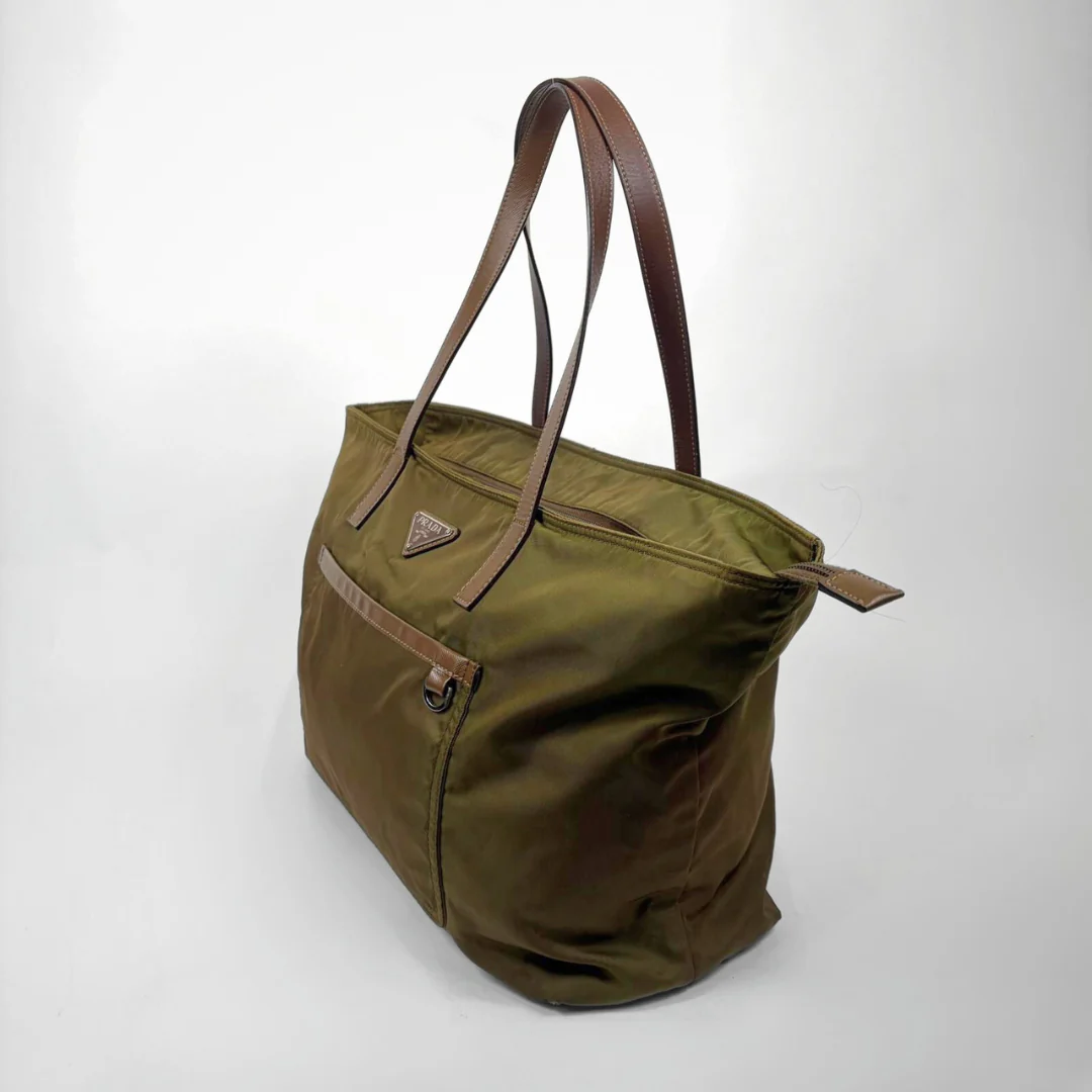Green bag with brown handles on a white background