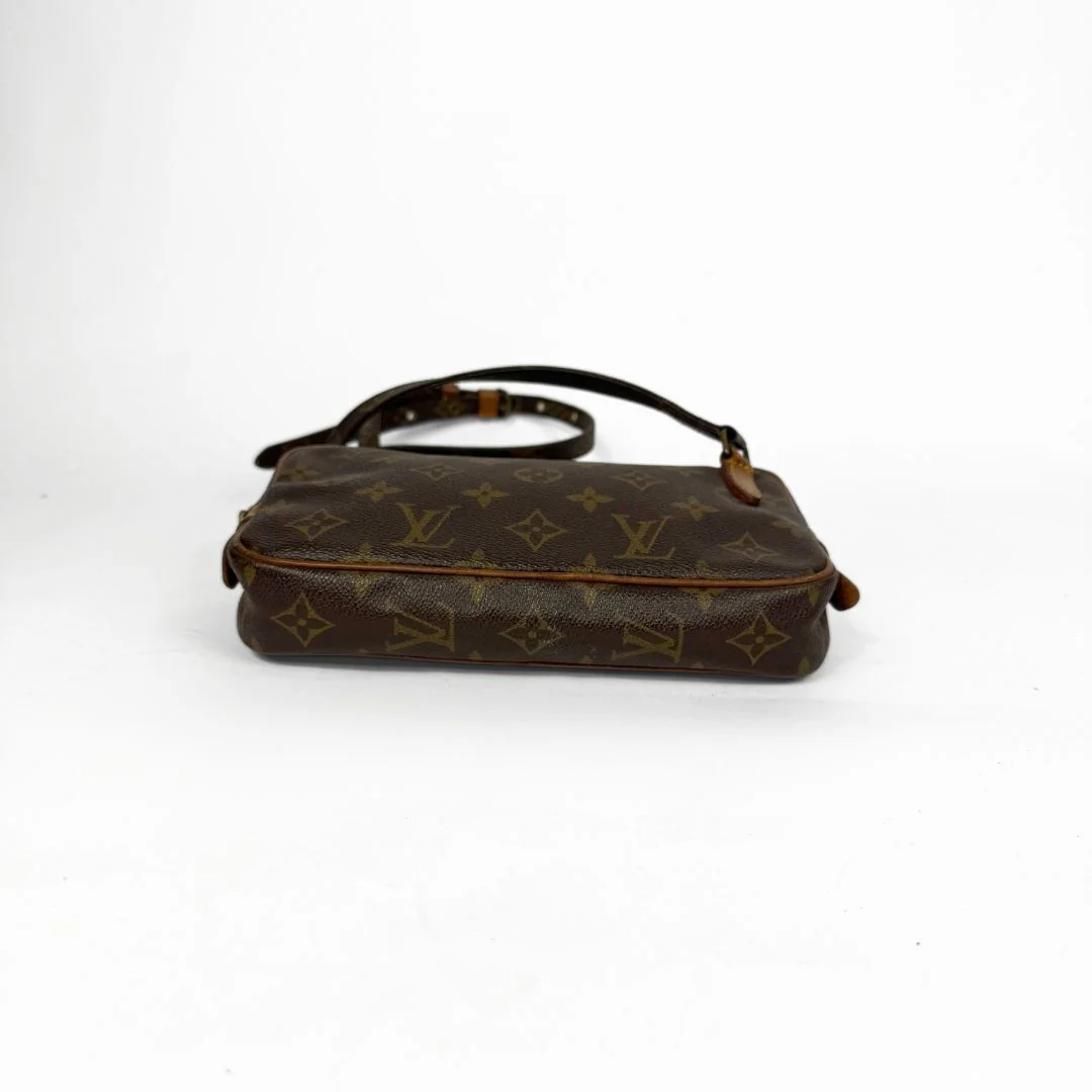 Brown handbag with monogram pattern on a white background