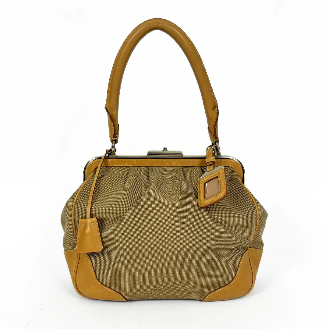 Brown handbag with tan accents on a white background
