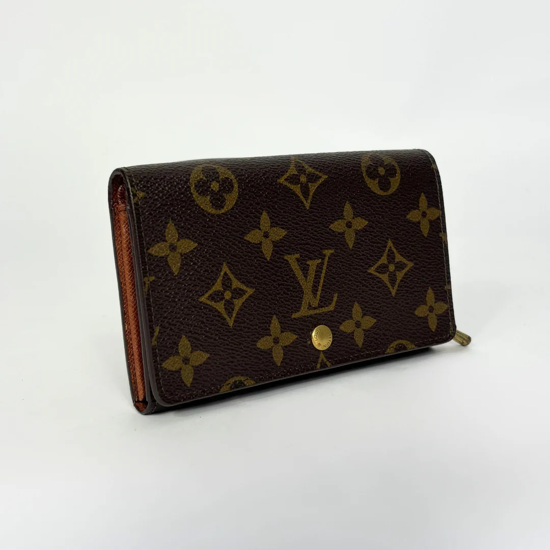 Louis Vuitton wallet with monogram pattern on a white background