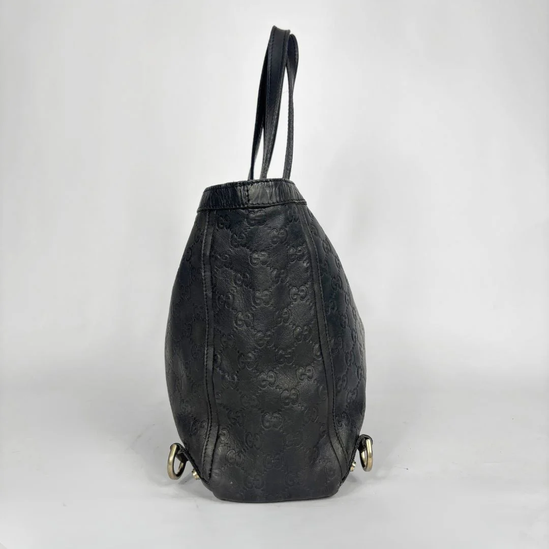 Black Gucci handbag on a white background