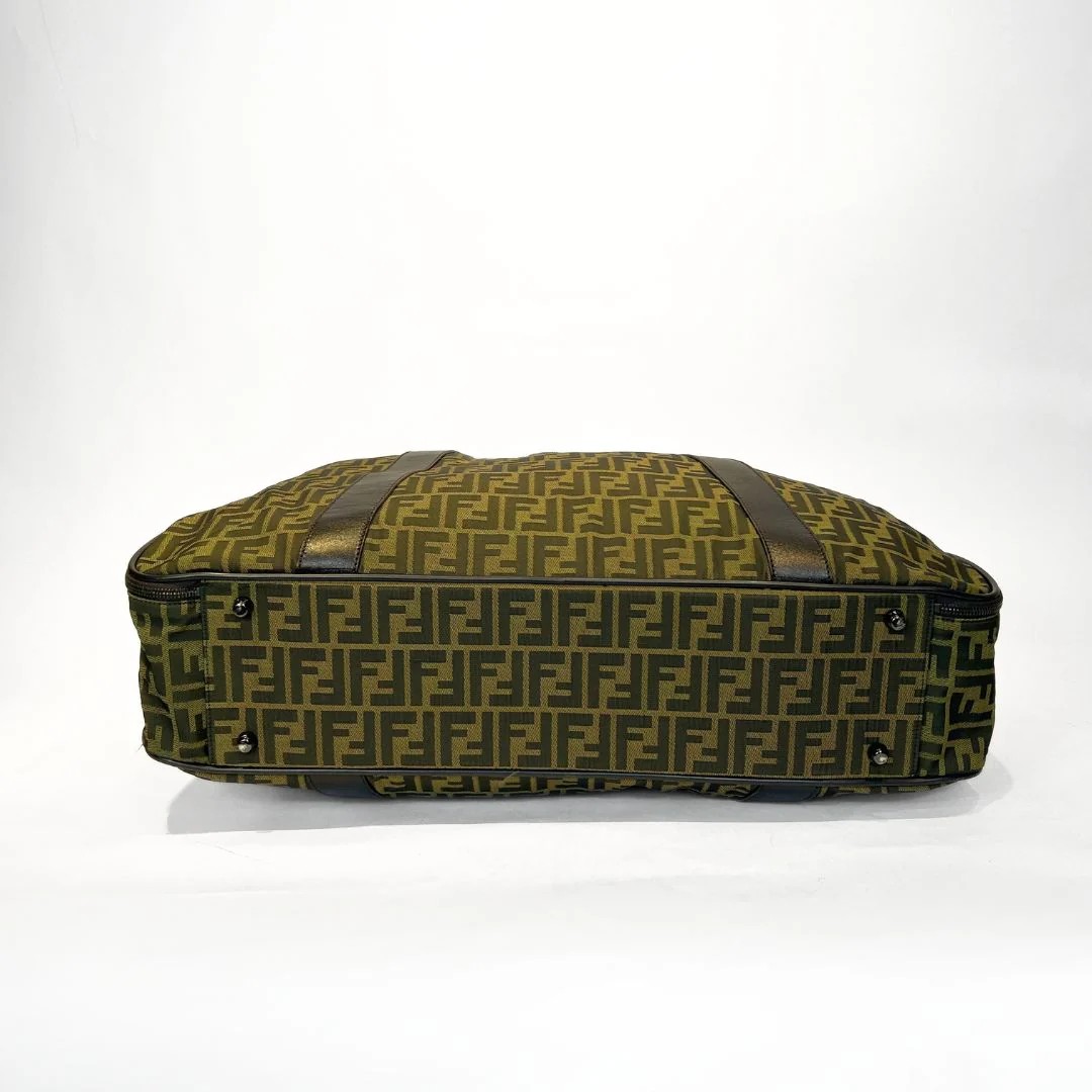 Green patterned bag with brown straps on a white background