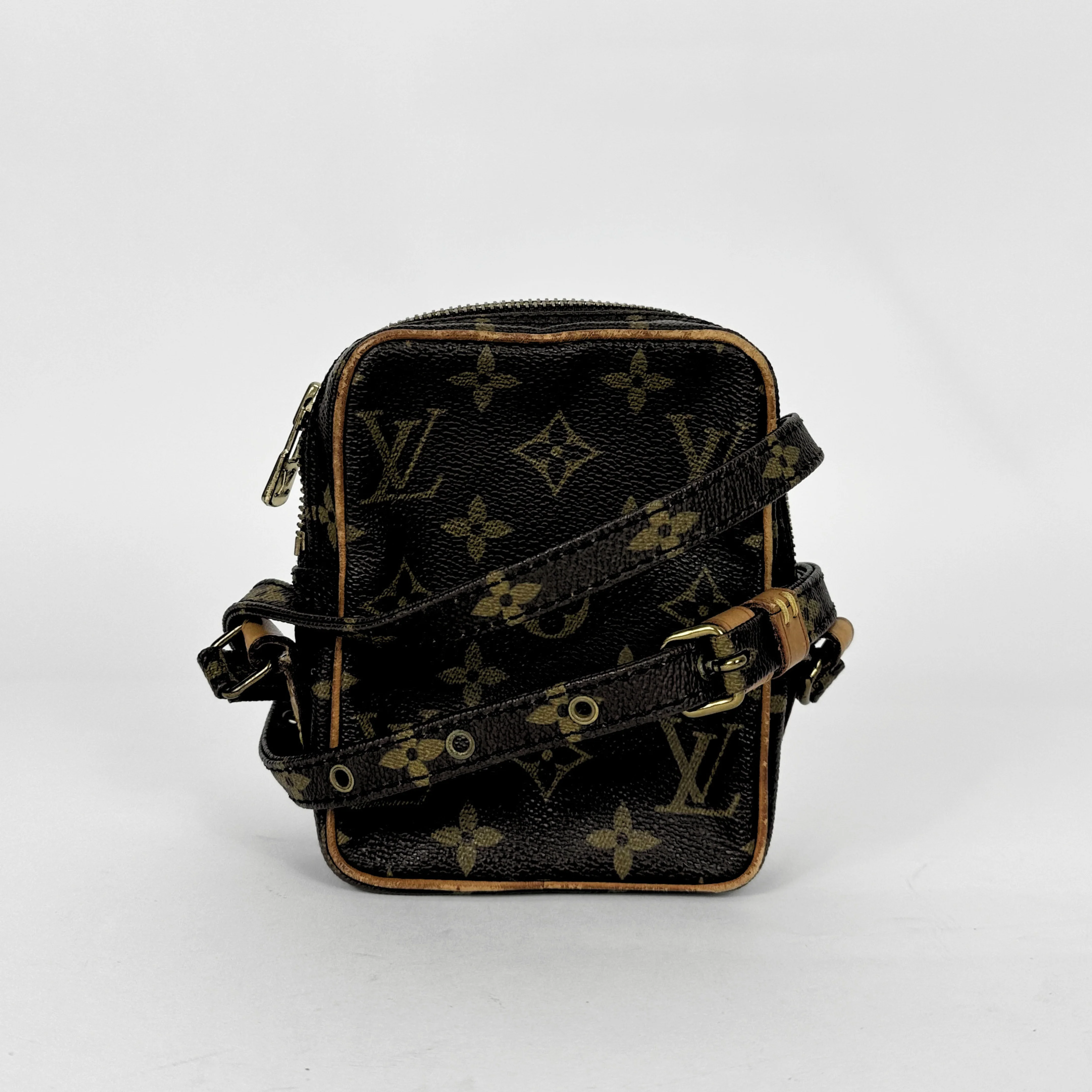 Black handbag with gold monogram pattern on a white background