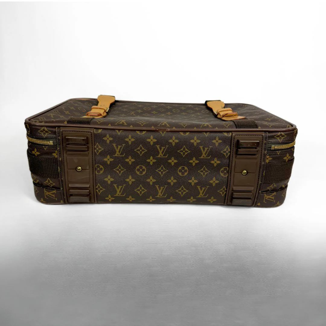 Brown suitcase with gold monogram pattern on a white background
