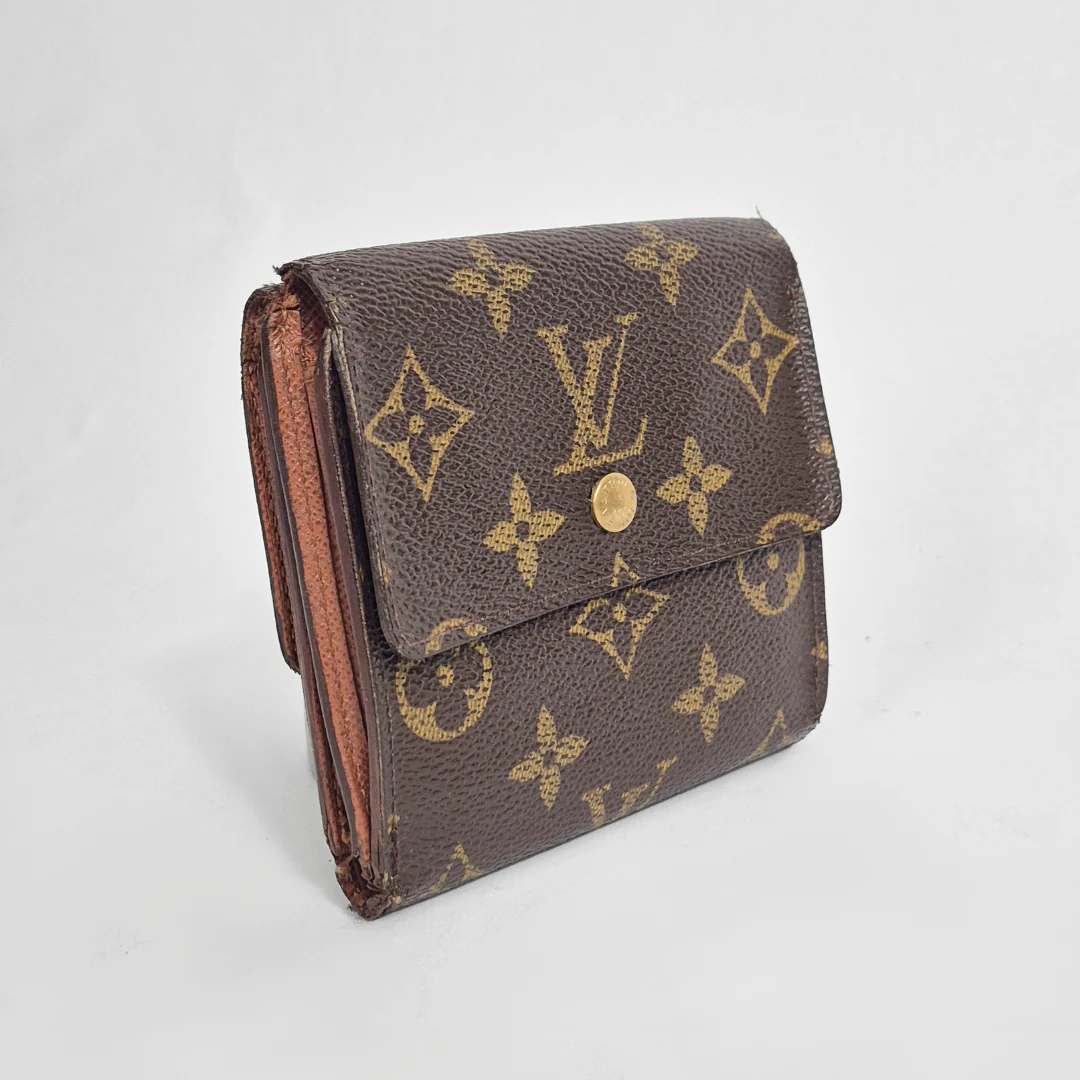 Louis Vuitton wallet with monogram pattern on a light gray background