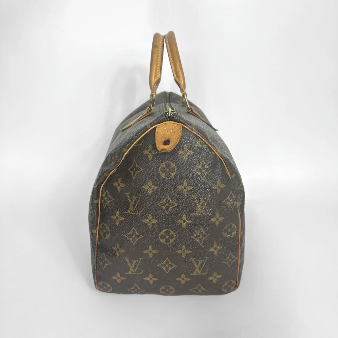 Brown handbag with a monogram pattern on a white background