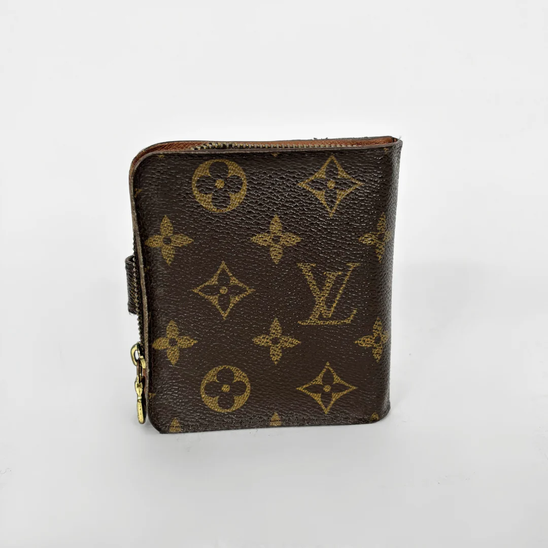 LV compact wallet in signature brown monogram canvas with a snap-button strap closure.