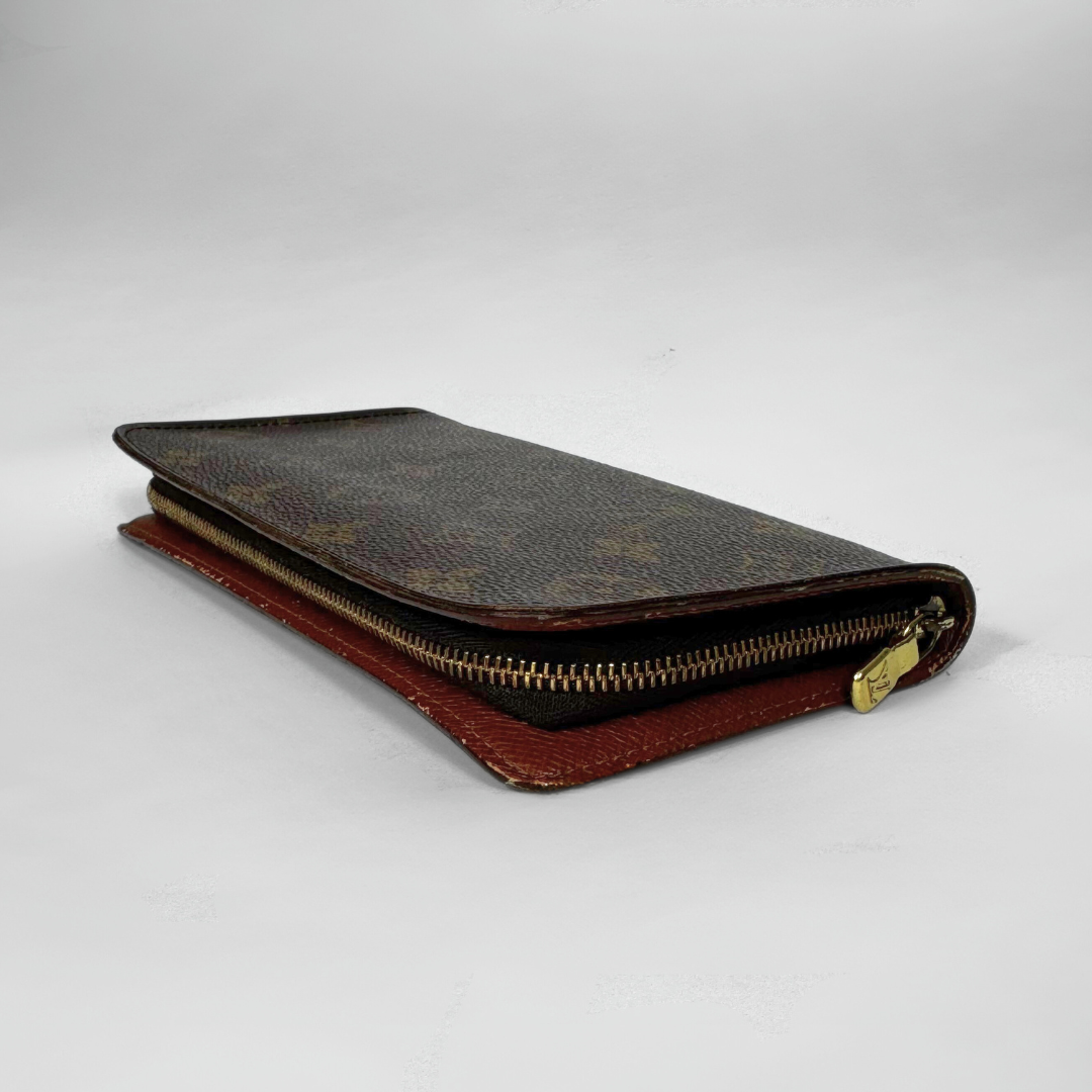 Brown leather wallet with gold zipper on a white background