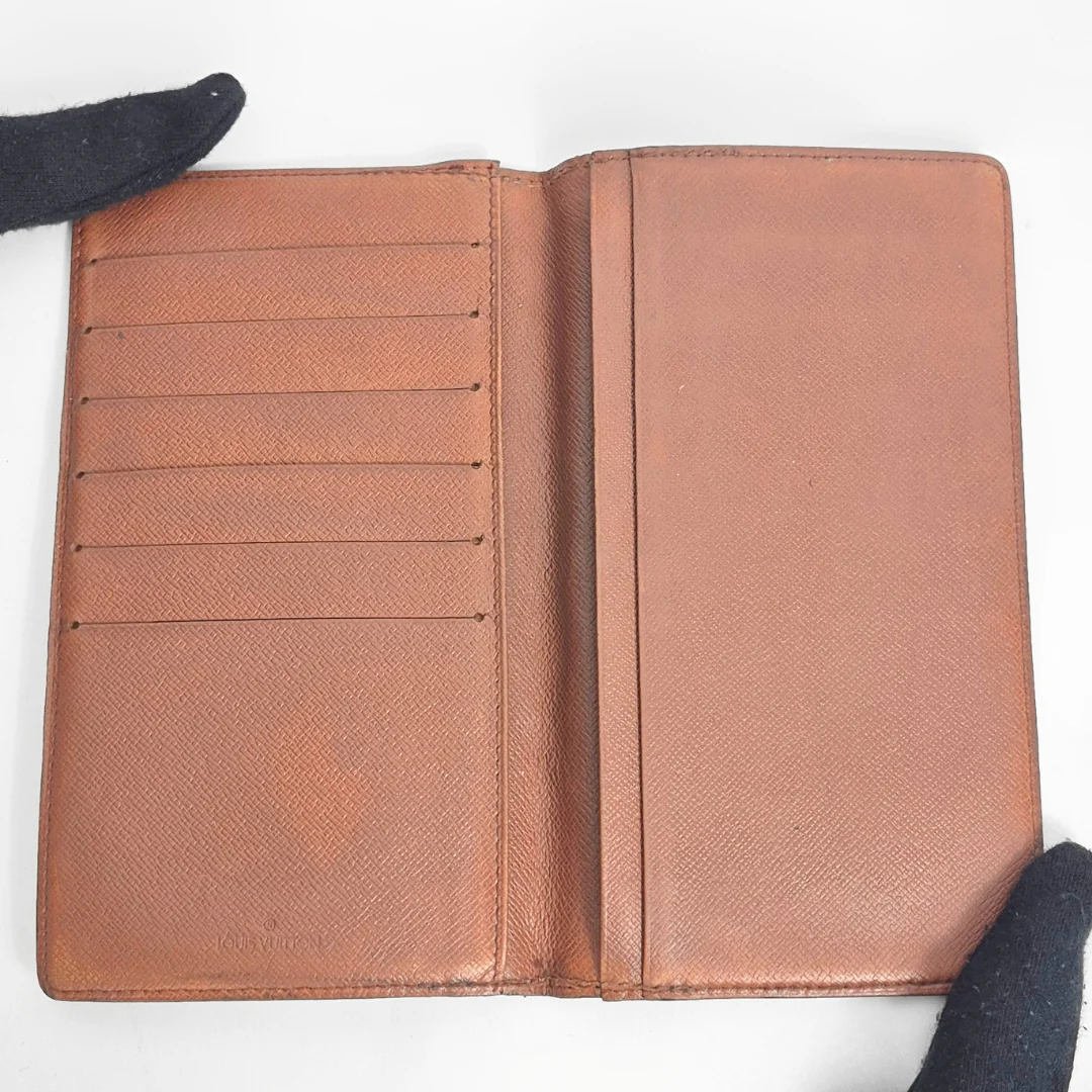 Brown leather wallet with multiple card slots on a white background