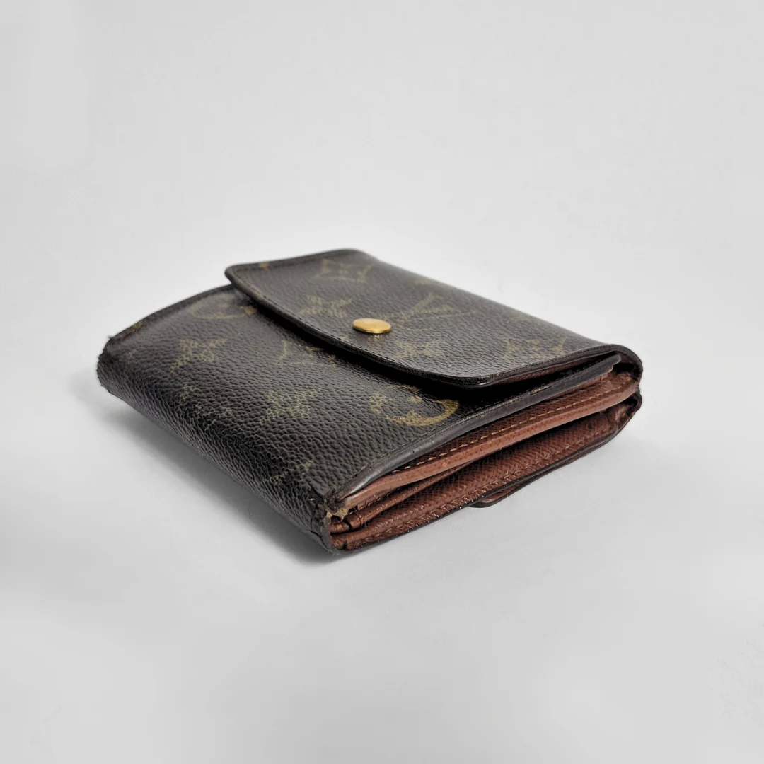 Folded brown leather wallet with a pattern on a light gray background