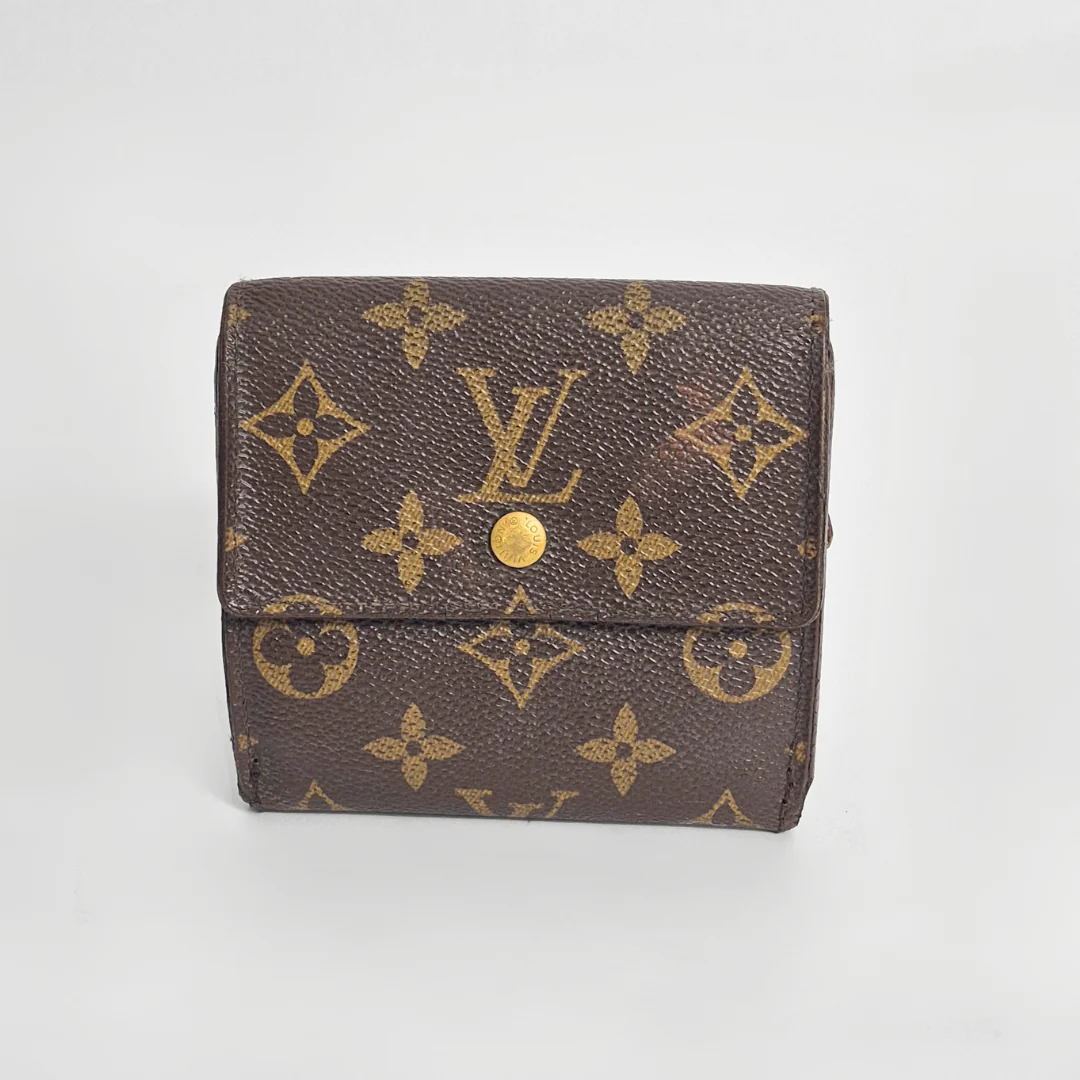 Louis Vuitton wallet with monogram pattern on a light gray background