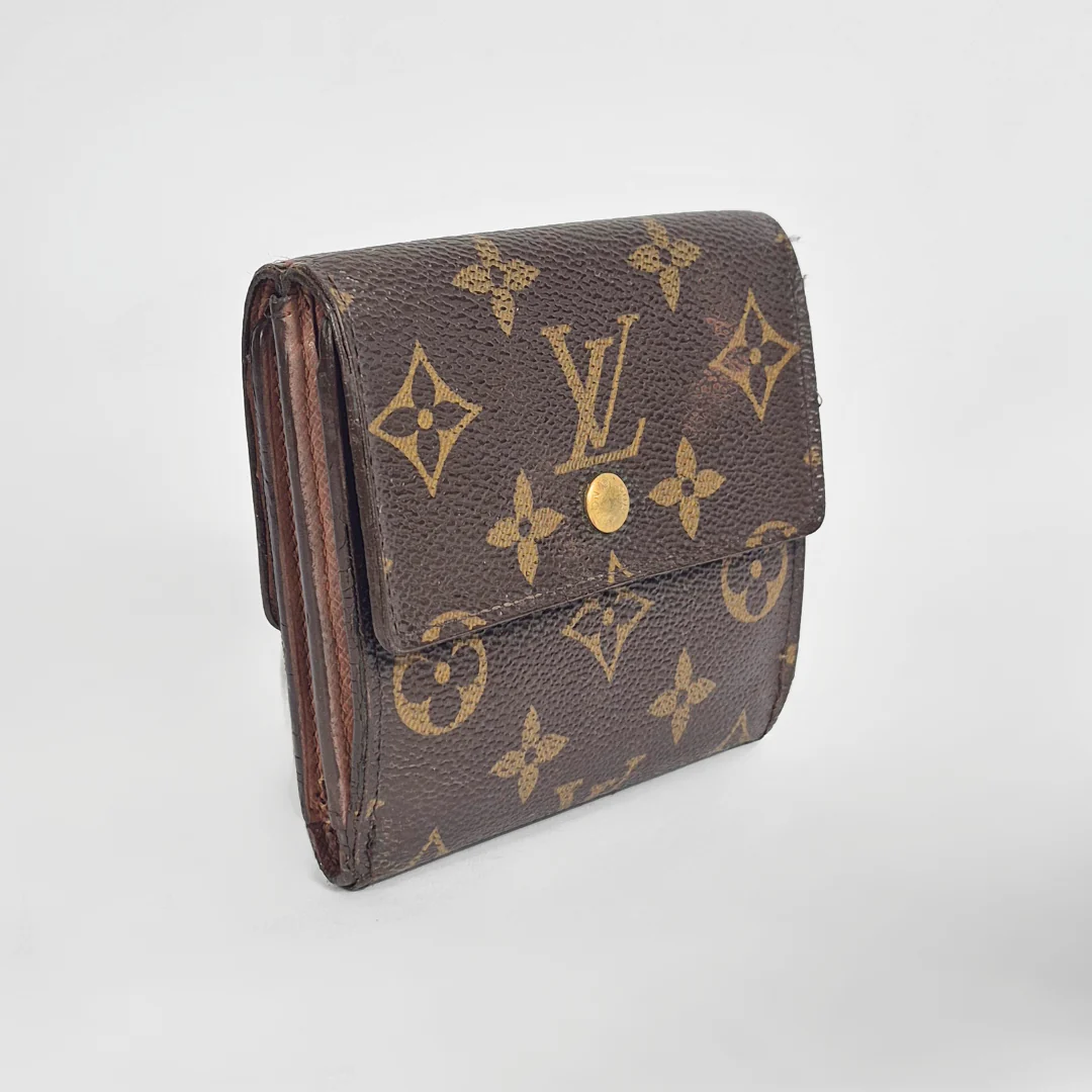 Louis Vuitton wallet with monogram pattern on a light gray background