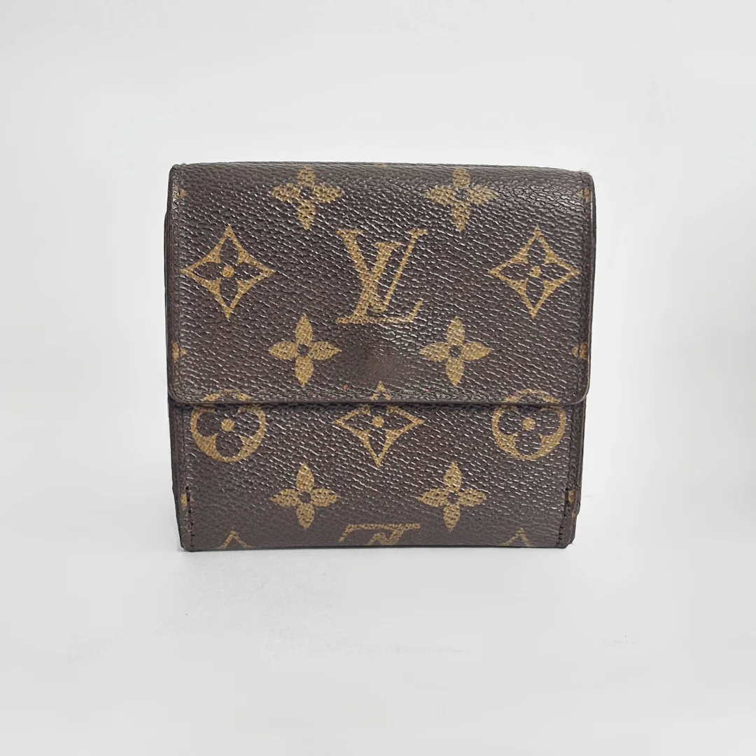 Louis Vuitton wallet with monogram pattern on a light gray background