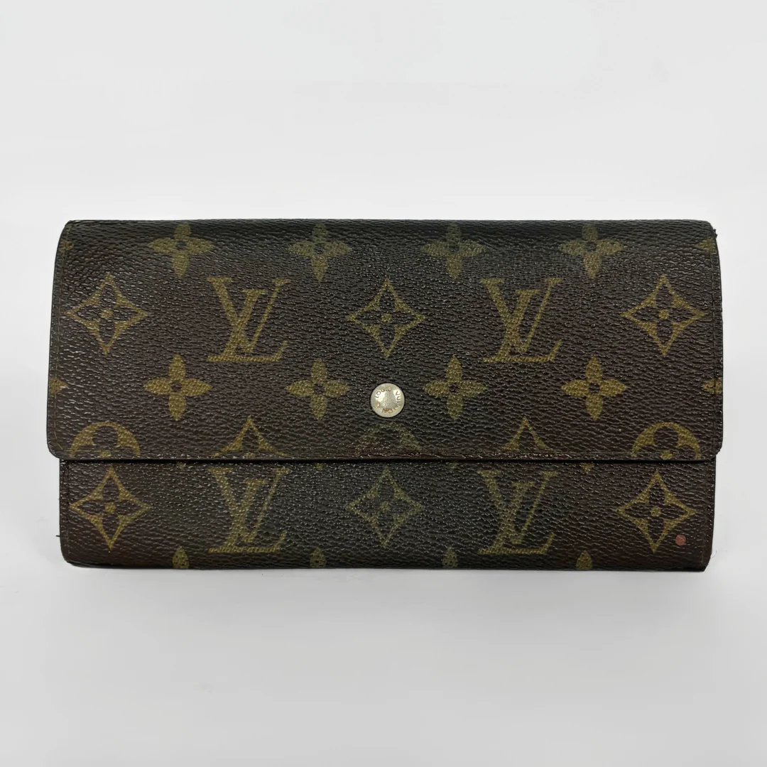 Louis Vuitton wallet with monogram pattern on a white background
