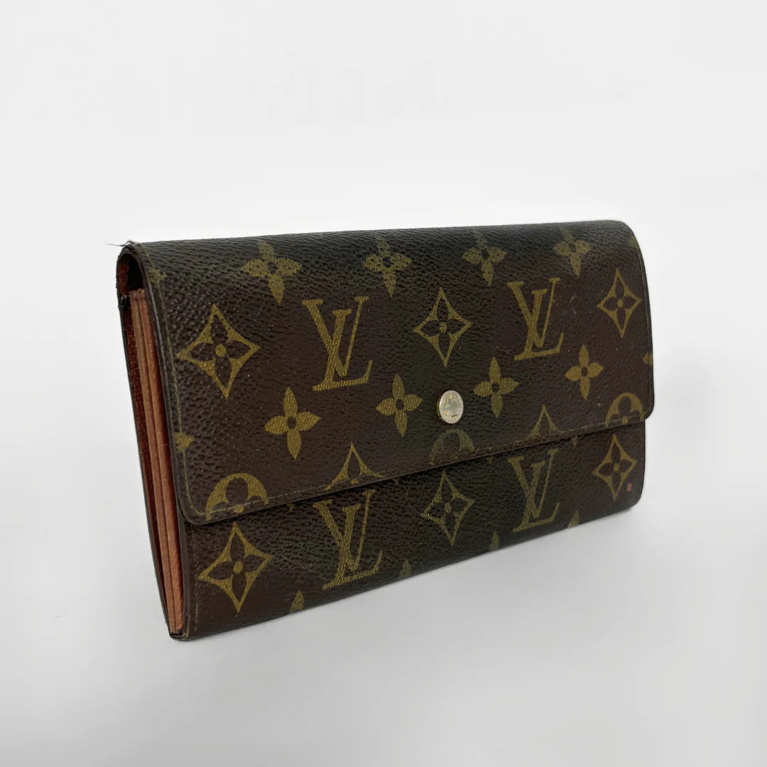 Louis Vuitton wallet with monogram pattern on a white background