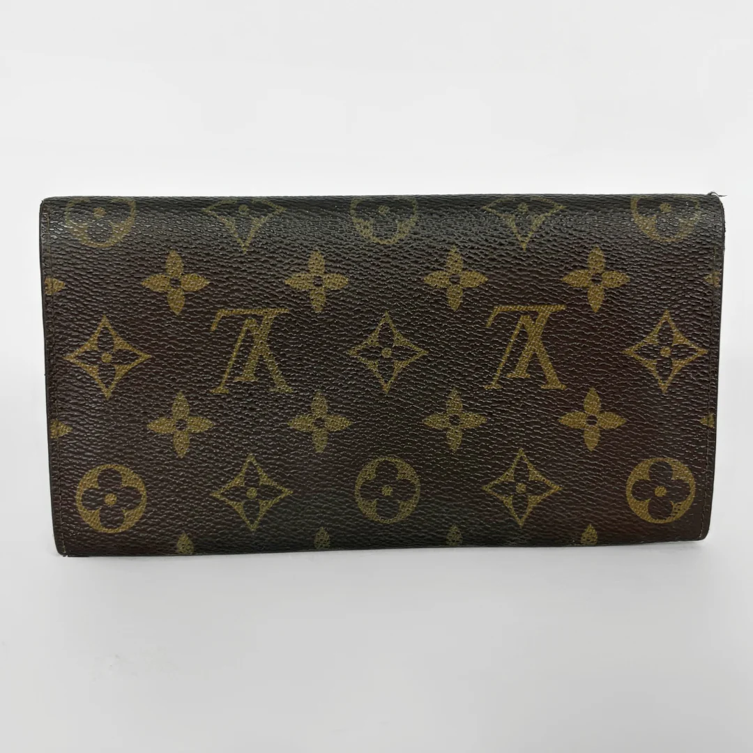 Louis Vuitton wallet with monogram pattern on a white background
