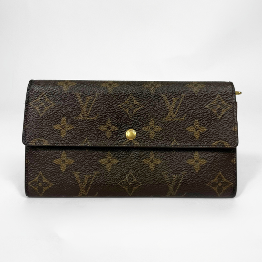 Brown leather wallet with gold monogram pattern on a white background