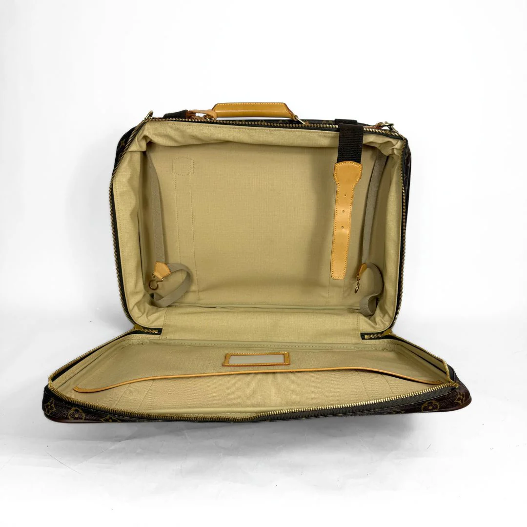 Open beige suitcase on a white background