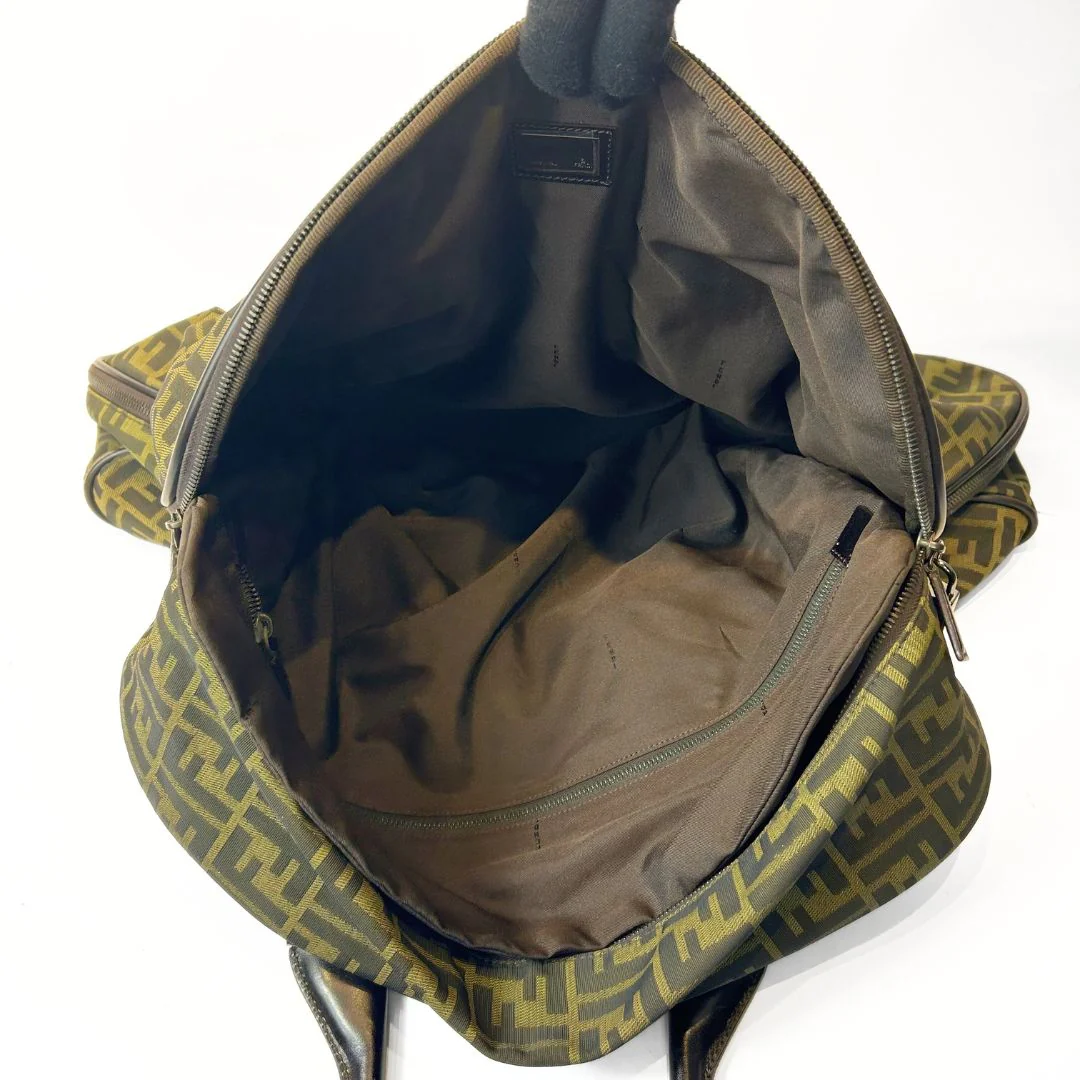 Open green and brown patterned backpack on a white background