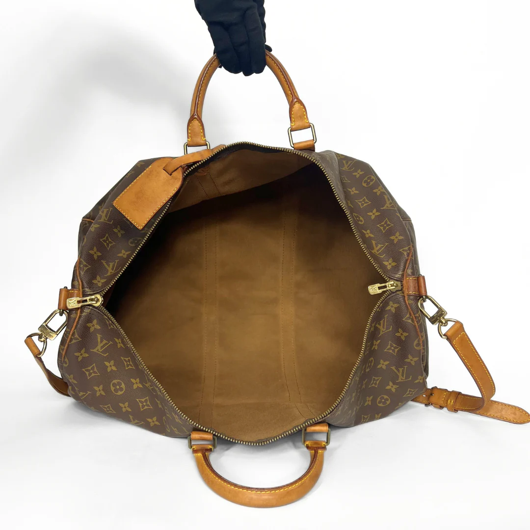 Brown leather handbag with gold hardware on a white background