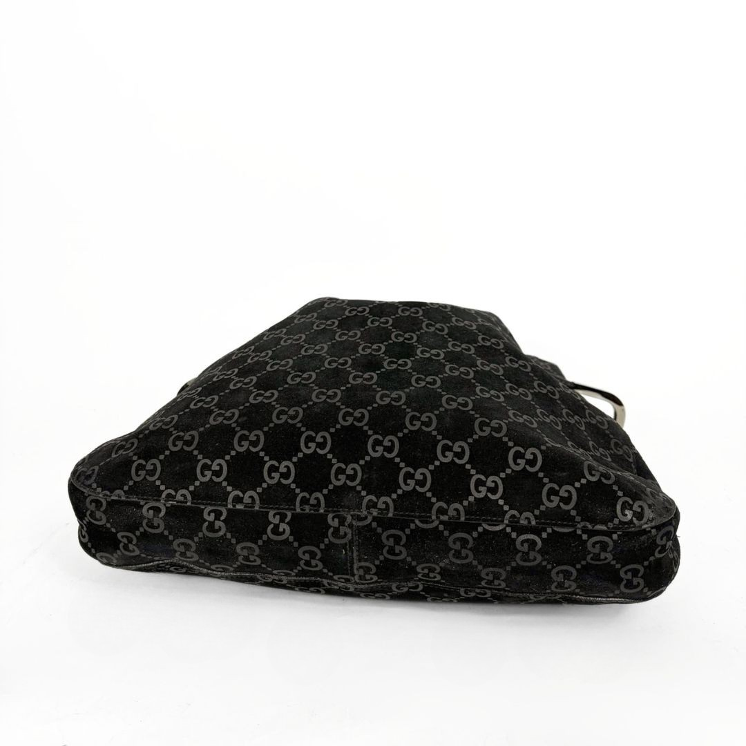 Gucci GG black suede shoulder bag on a white background