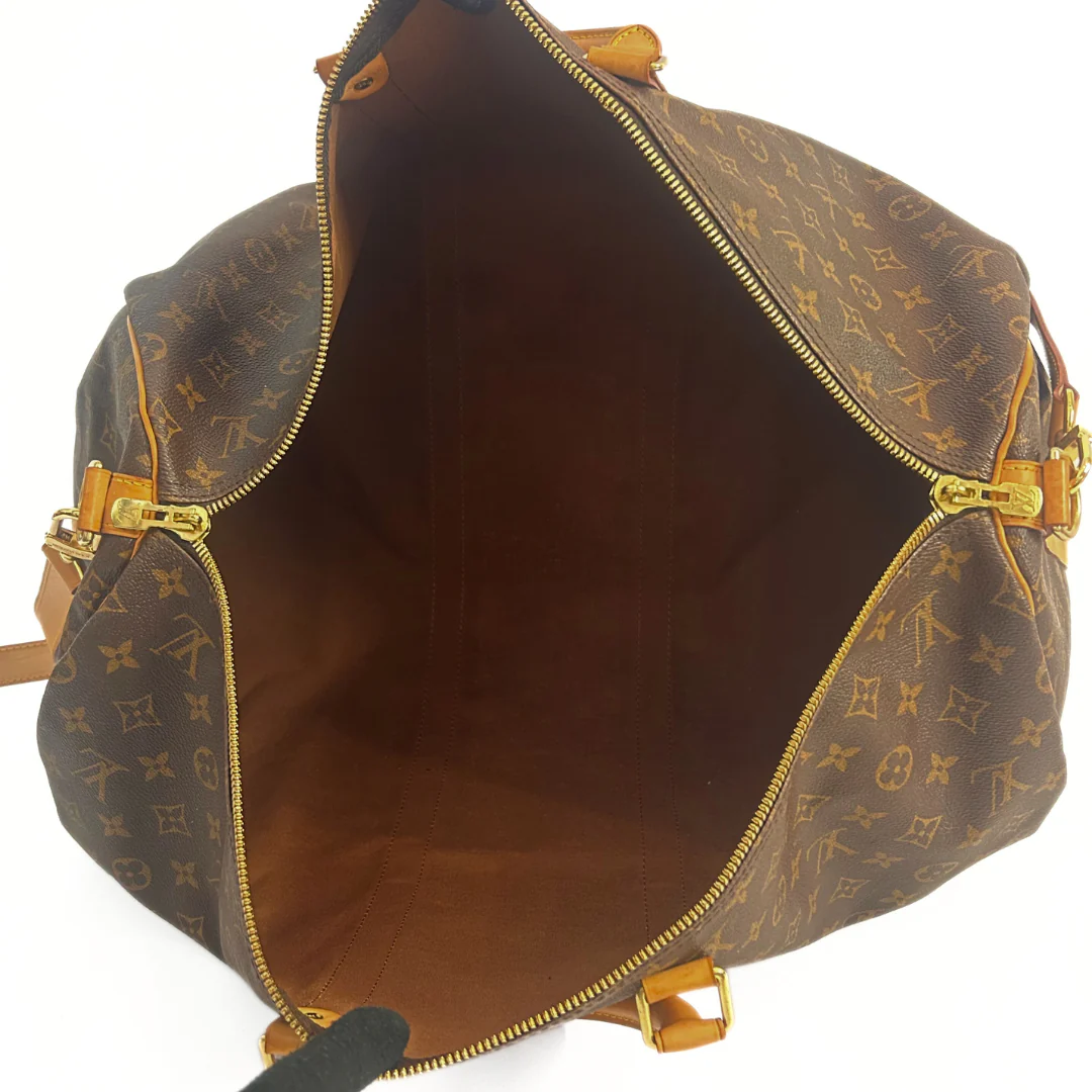 Brown leather bag with gold accents on a white background
