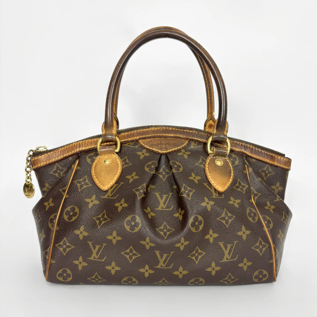 Brown handbag with gold accents on a white background