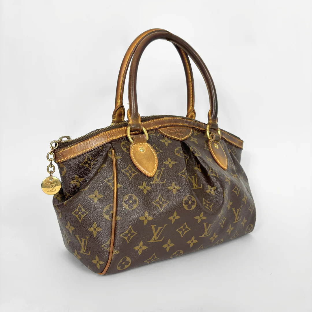 Brown handbag with gold accents on a white background