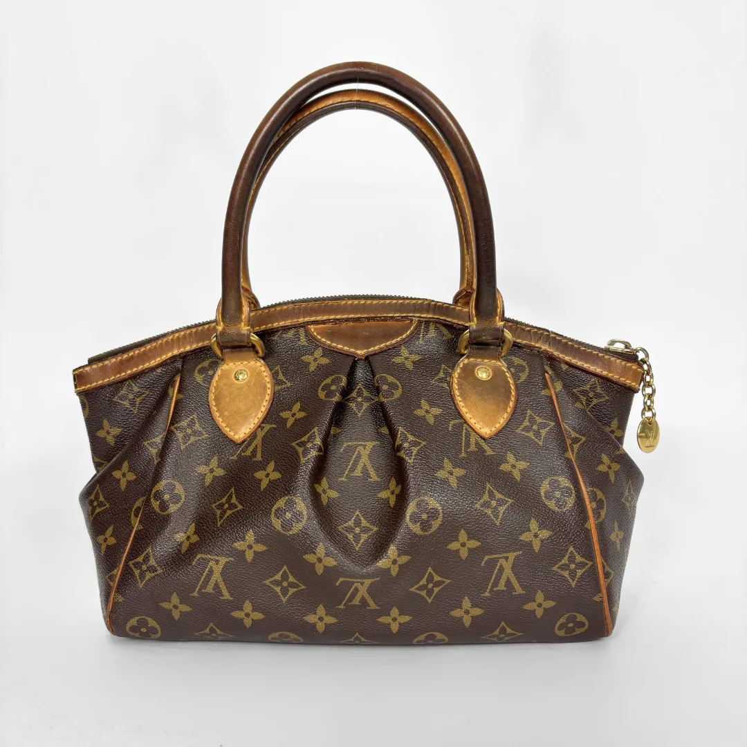 Brown handbag with gold accents on a white background