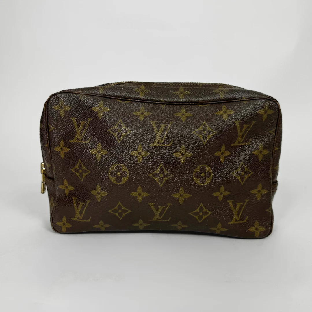 Brown leather pouch with gold monogram pattern on a white background