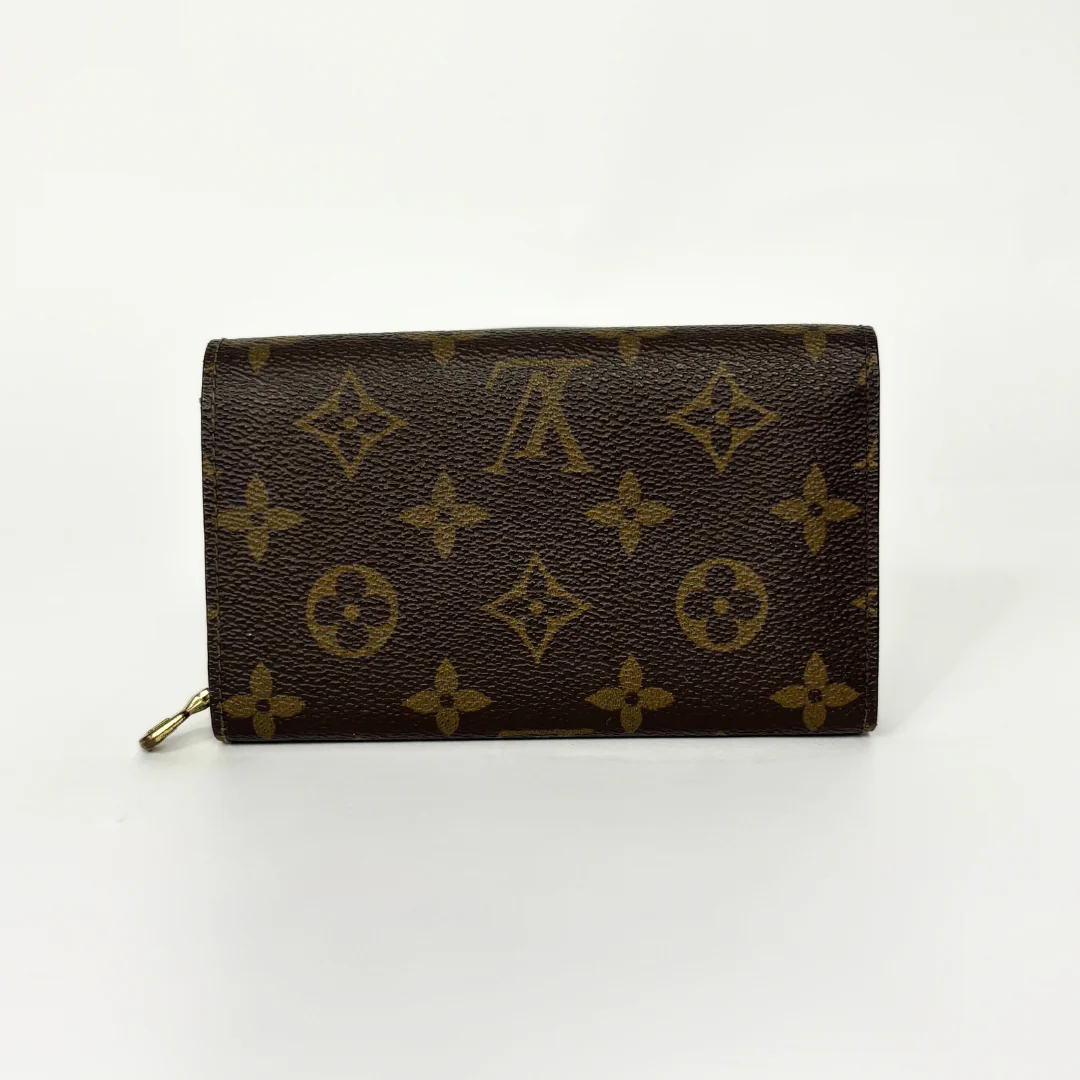 Louis Vuitton wallet with monogram pattern on a white background