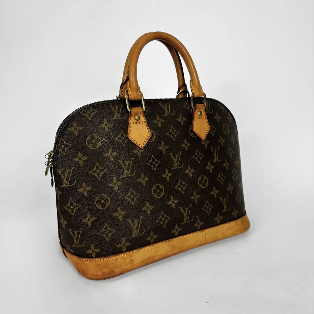 Louis Vuitton monogram canvas dome handbag with tan leather handles and trim, photographed on a light gray studio background.