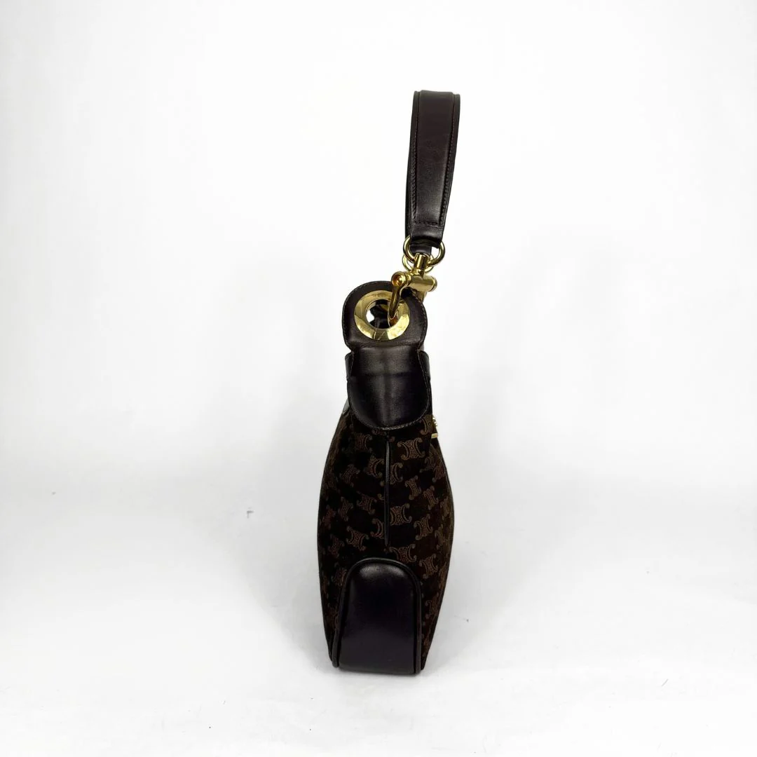 Black patterned umbrella with gold handle on a white background